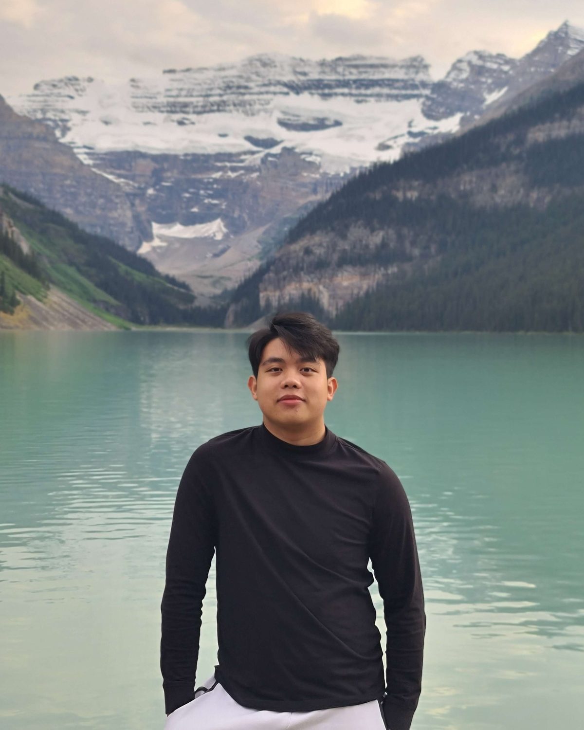 Portrait of William Edwardo Gunawan by a mountain lake